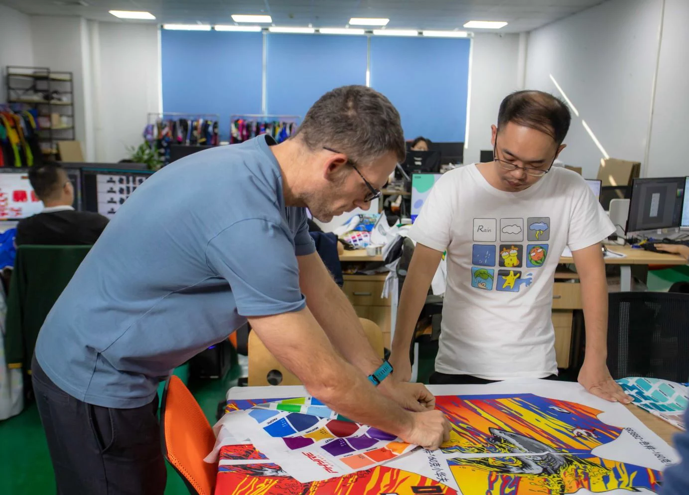 Sam Clay working with staff in factory