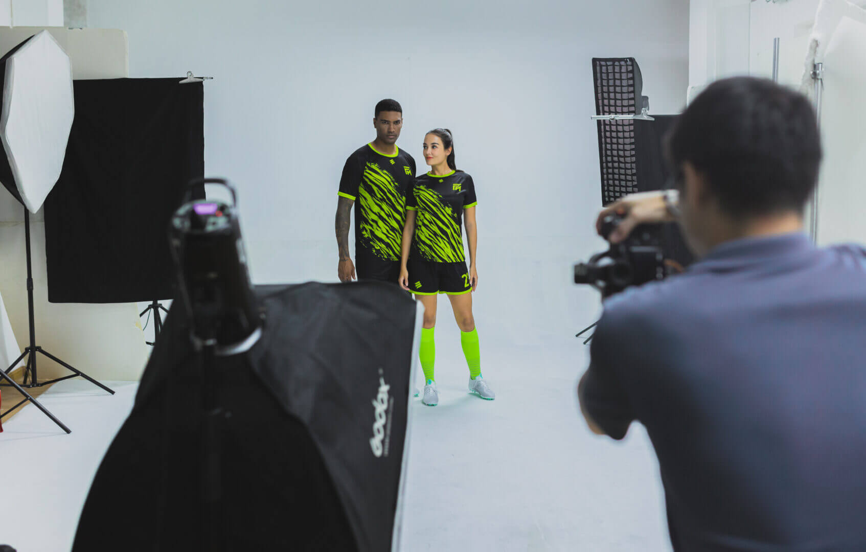Male and female models posting together for apparel photography service shoot